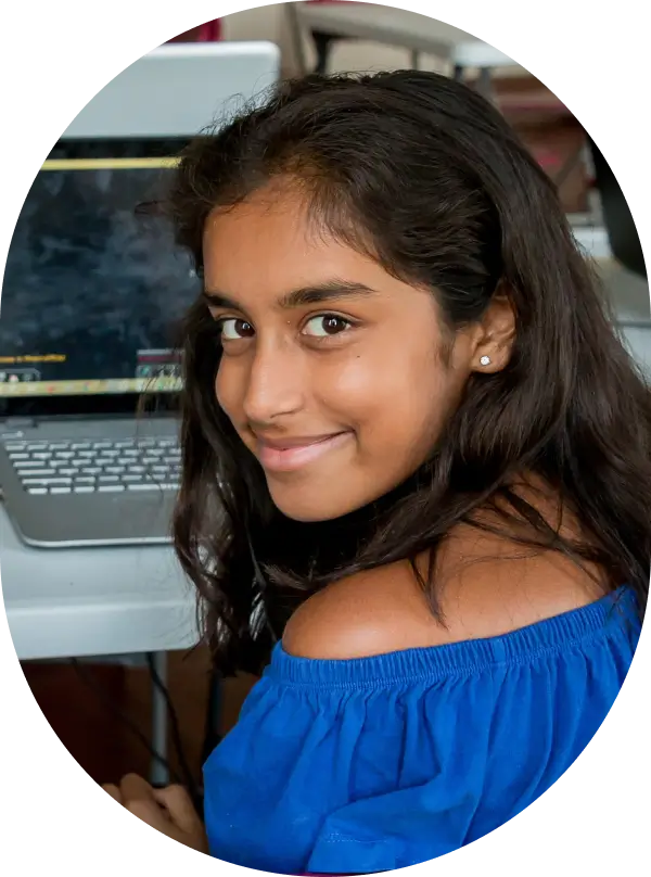 Child on computer working coding and smiling
